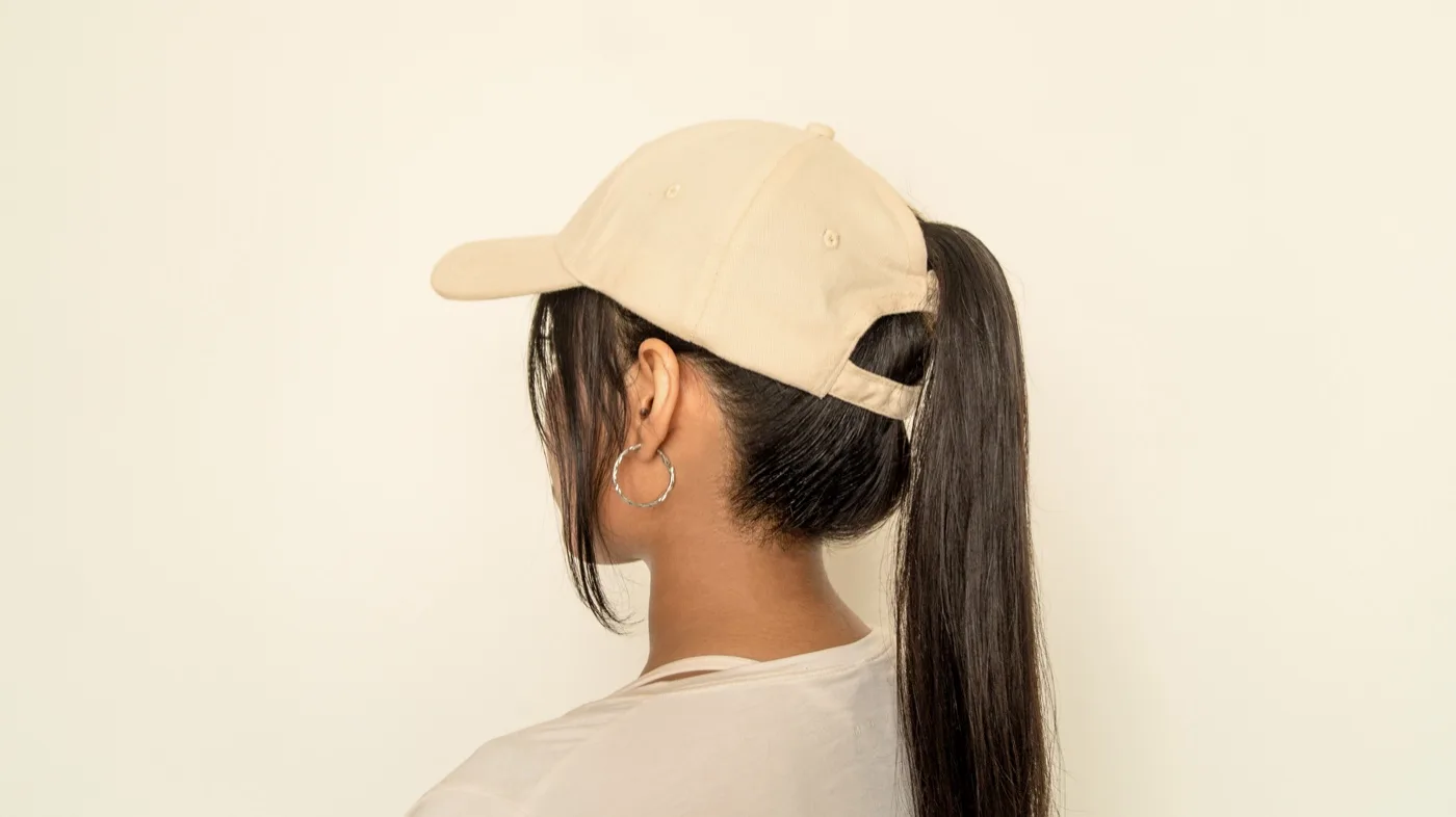 Worn with a low ponytail, side view