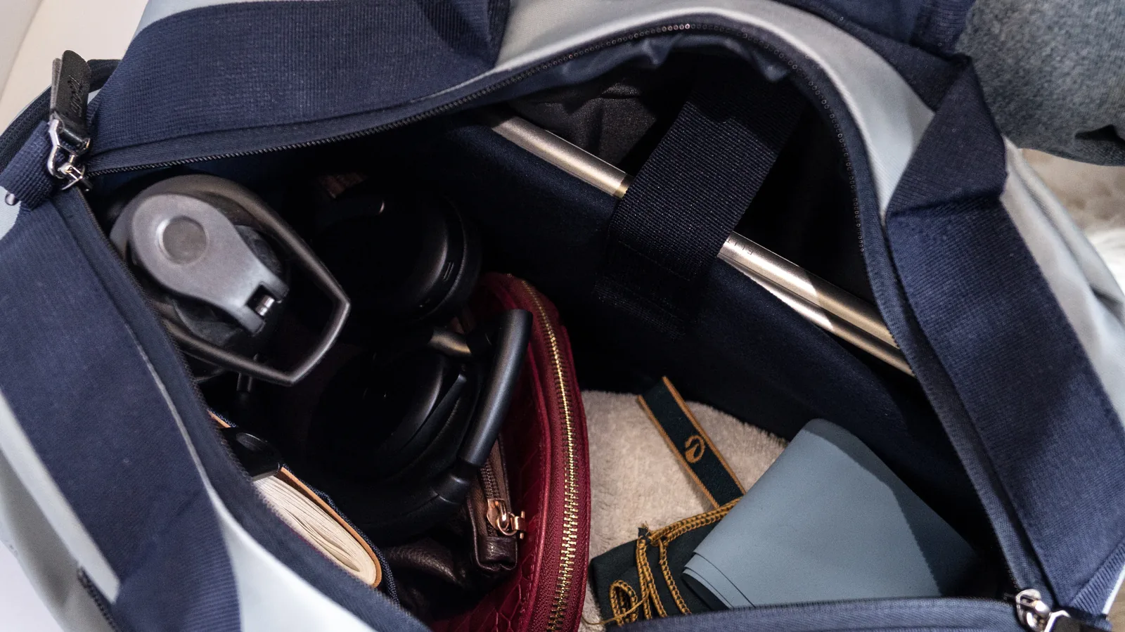 Inside the Slate Duffel, packed with headphones, a wallet and a charger