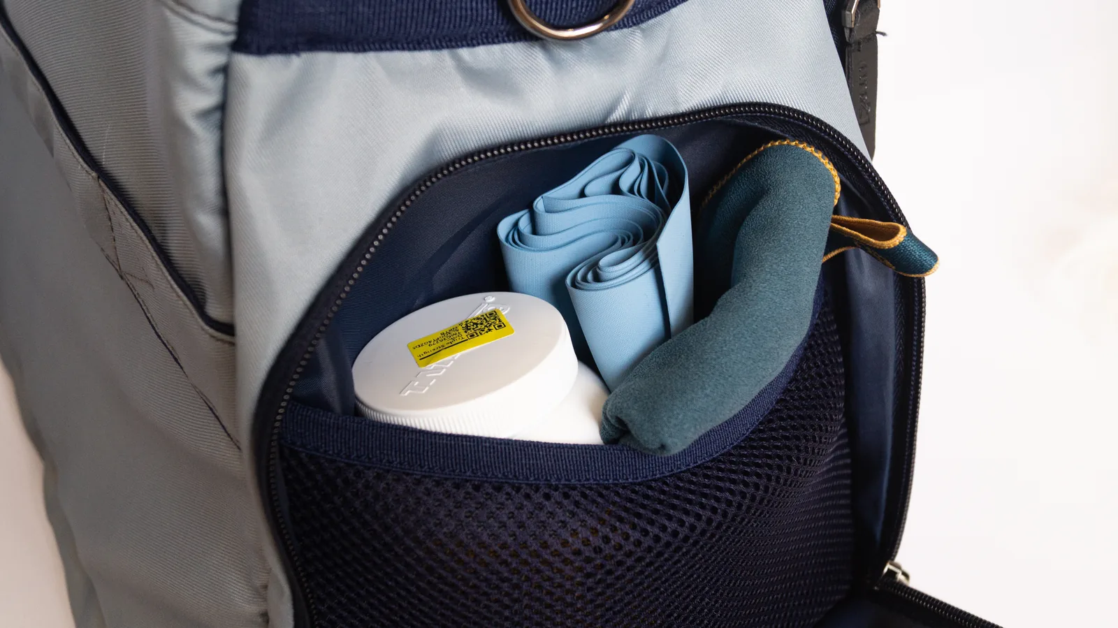 The mesh organiser pocket, holding a towel and toiletries